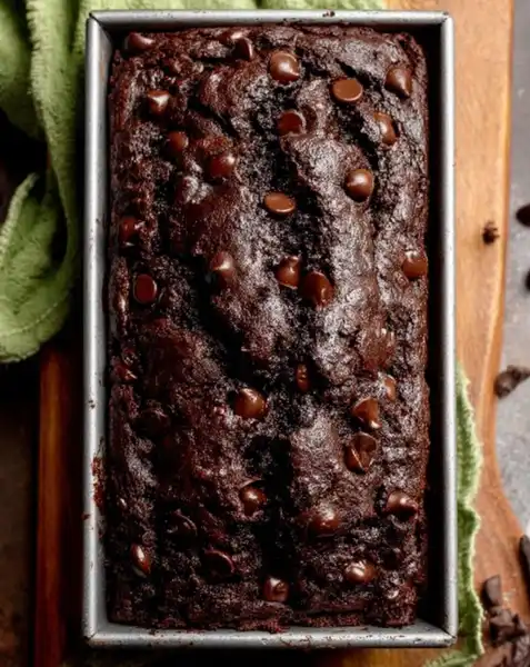 Chocolate_Zucchini_Bread_1_result A sliced loaf of moist chocolate zucchini bread on a cooling rack
