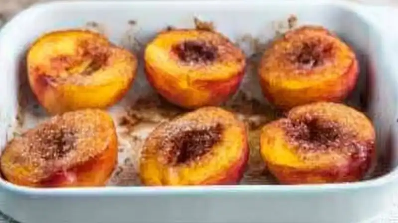 Cinnamon_Sugar_Baked_0_result Peach halves in a baking dish with a cube of butter placed in the center before baking