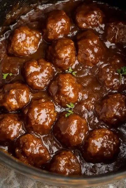 Crockpot_Salisbury_Steak_0_result Pouring savory gravy over frozen meatballs in the crockpot