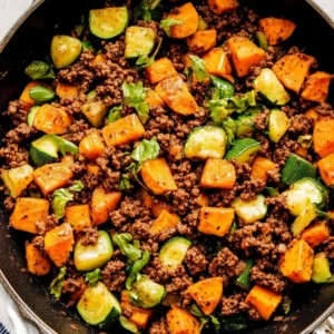 Adding diced Brussels sprouts to the Ground Beef Sweet Potato Skillet, part of the #1 secret for a perfectly balanced one-pan meal.