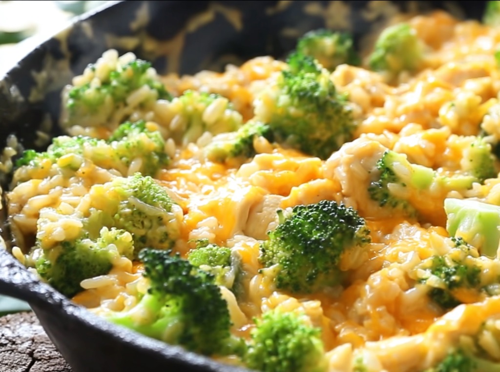 one_pan_cheesy_chicken_2 A close-up of a spoonful being lifted from the skillet, showing a glorious, stringy cheese pull from the cheesy chicken, broccoli, and rice.