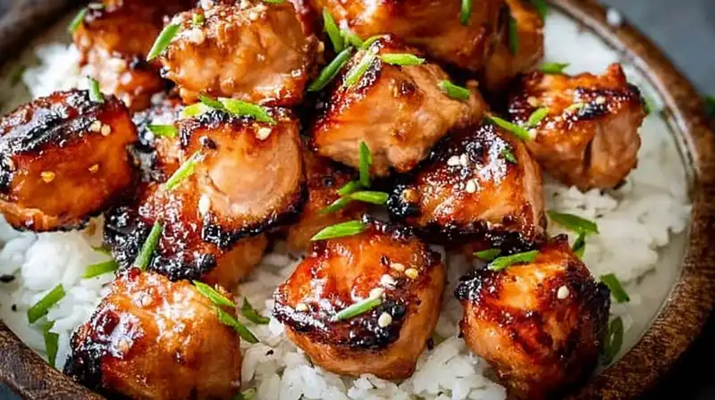 Air fryer bang bang salmon bites served with fresh herbs