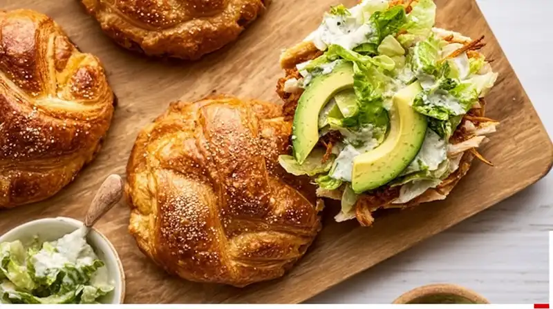 Chicken_Caesar_Croissant_0_result Chicken Caesar Croissant Sandwich cutlets breaded and ready to fry on a prep board