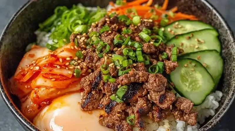 Overhead view of a complete Korean BBQ rice bowl garnished with sesame seeds