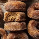 Close up of baked apple cider donuts with sparkly cinnamon sugar crust