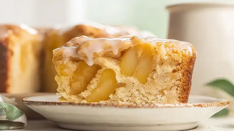 Freshly baked apple pie coffee cake with vanilla glaze drizzle