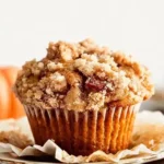 Freshly baked pumpkin muffins with apple cinnamon crumble
