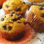 Close-up of moist pumpkin muffins filled with chocolate chips on a cooling rack