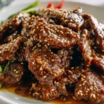 Crispy sesame beef coated in glossy sauce and topped with toasted sesame seeds