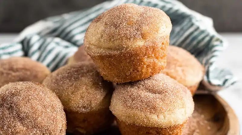 Warm donut muffins dipped in butter and rolled in cinnamon sugar