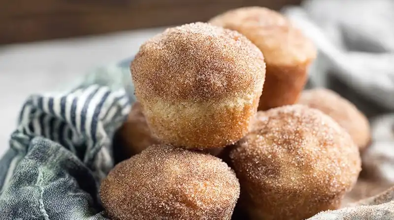 Cinnamon_Sugar_Donut_Muf_2_result Cinnamon sugar donut muffins on a tray with buttery coating
