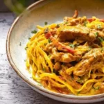 Plated linguine in glossy cowboy butter sauce with peppers parsley and Parmesan