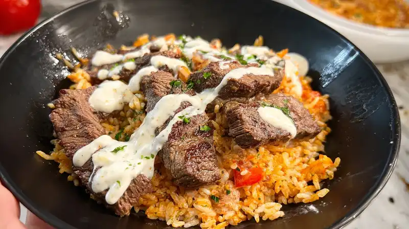 Steak queso rice bowl with seared sirloin cilantro and warm white queso